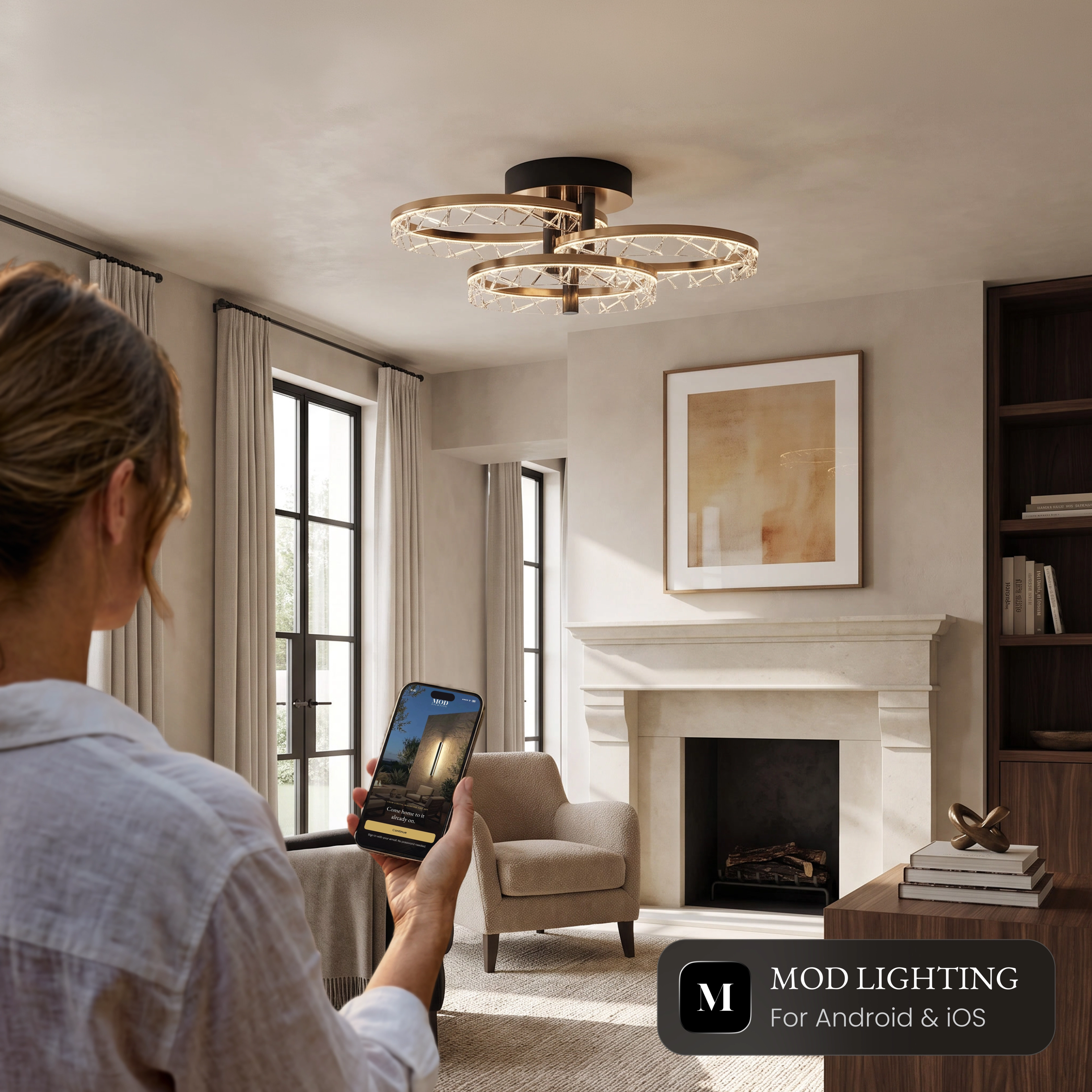 Woman controlling the Clara Smart ceiling light from the MOD Smart Home app on her phone