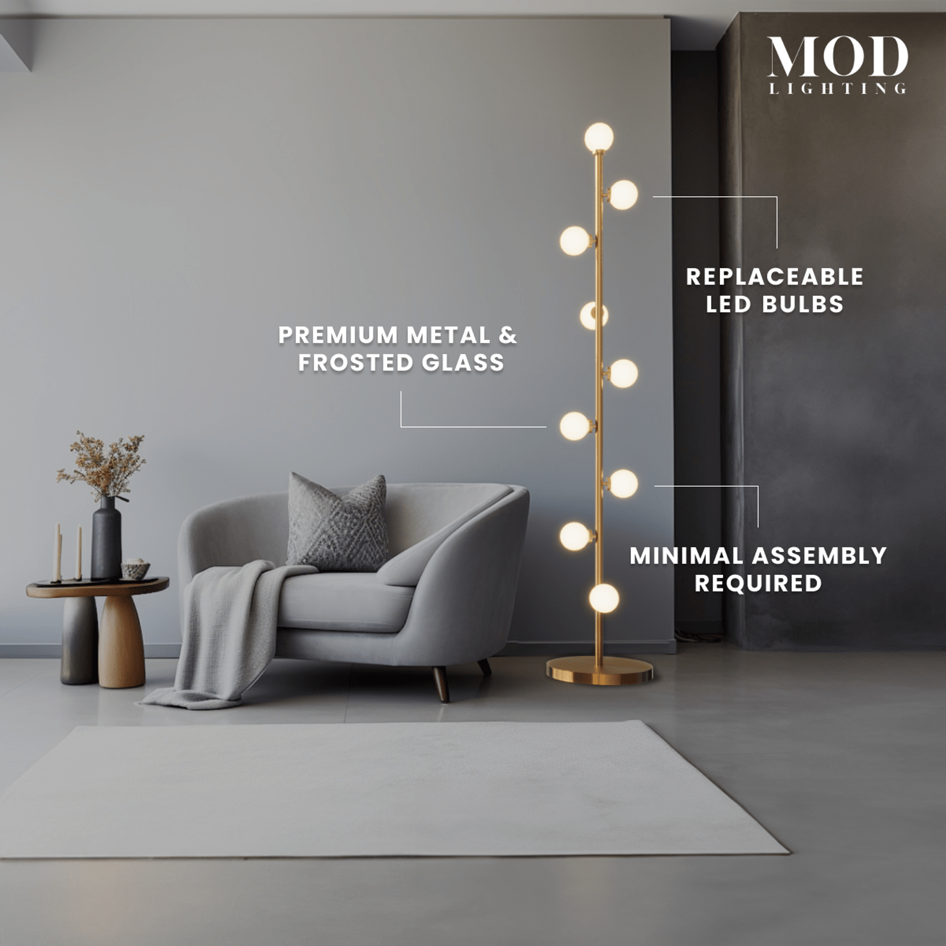 Pearl floor lamp in gold beside a grey armchair in a living room; frosted glass globes stacked on a slim metal stem