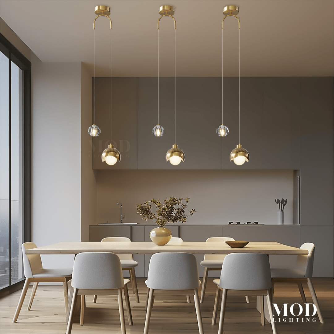Diana, row of clear glass globe pendants on gold stems over a dining table