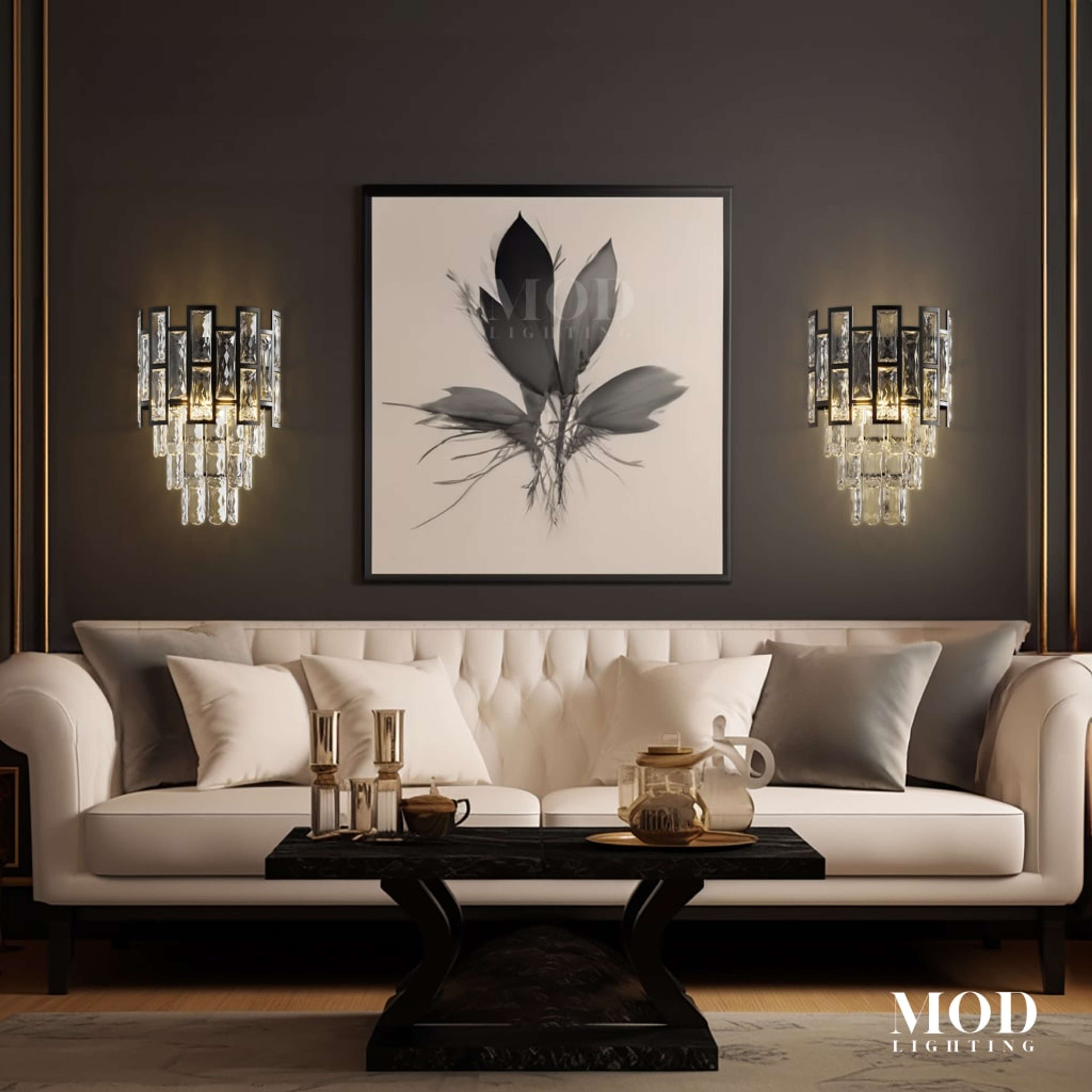 Raven black crystal sconces, tiered faceted-glass fixtures flanking wall art above a cream sofa
