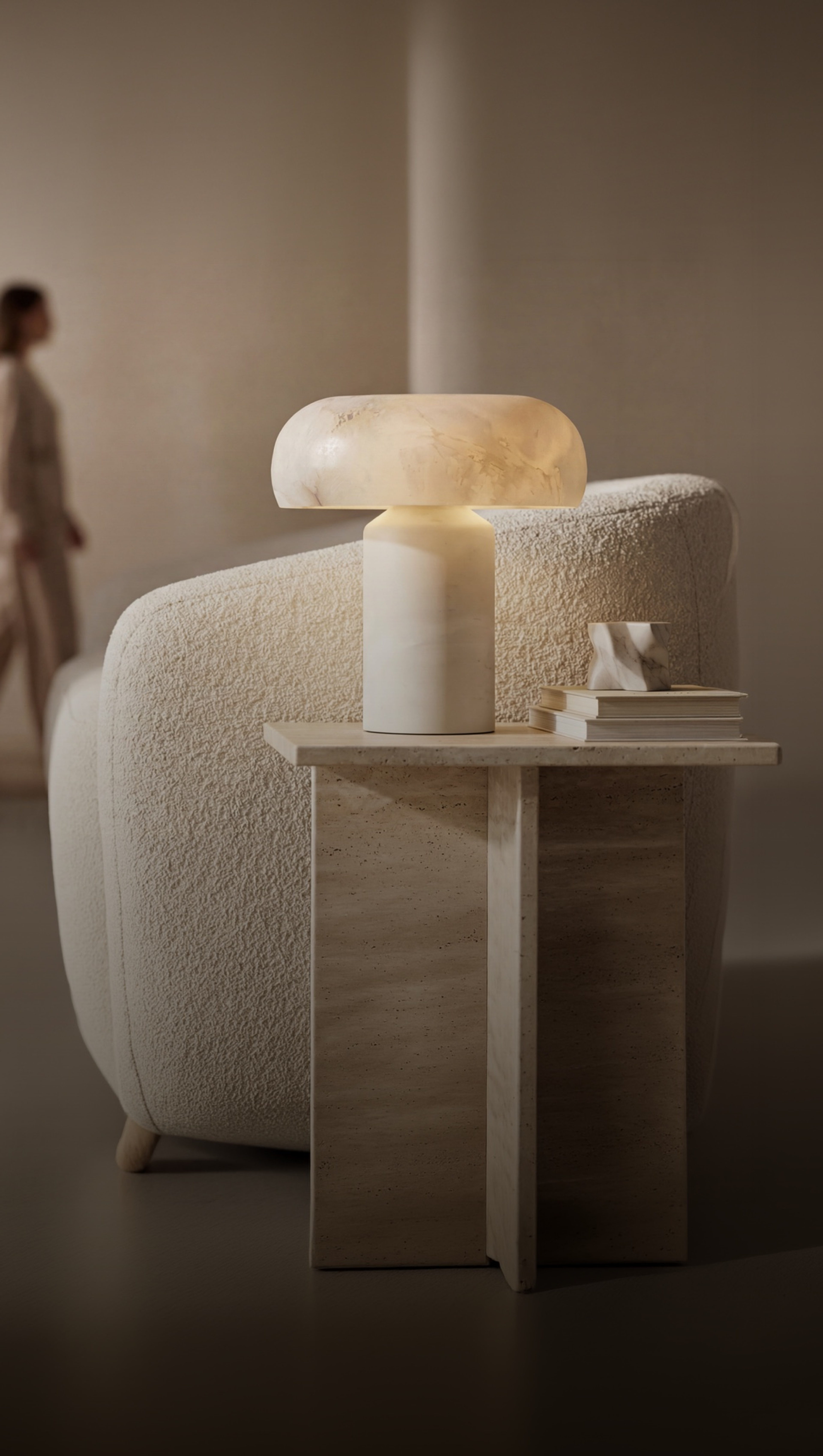 MOD LIGHTING alabaster table lamp on a travertine side table in a warm modern living room
