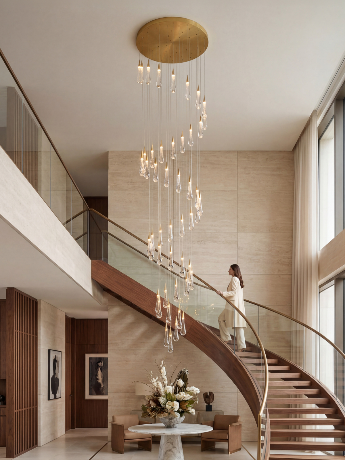 Crystal cascade chandelier lighting a double height curved staircase