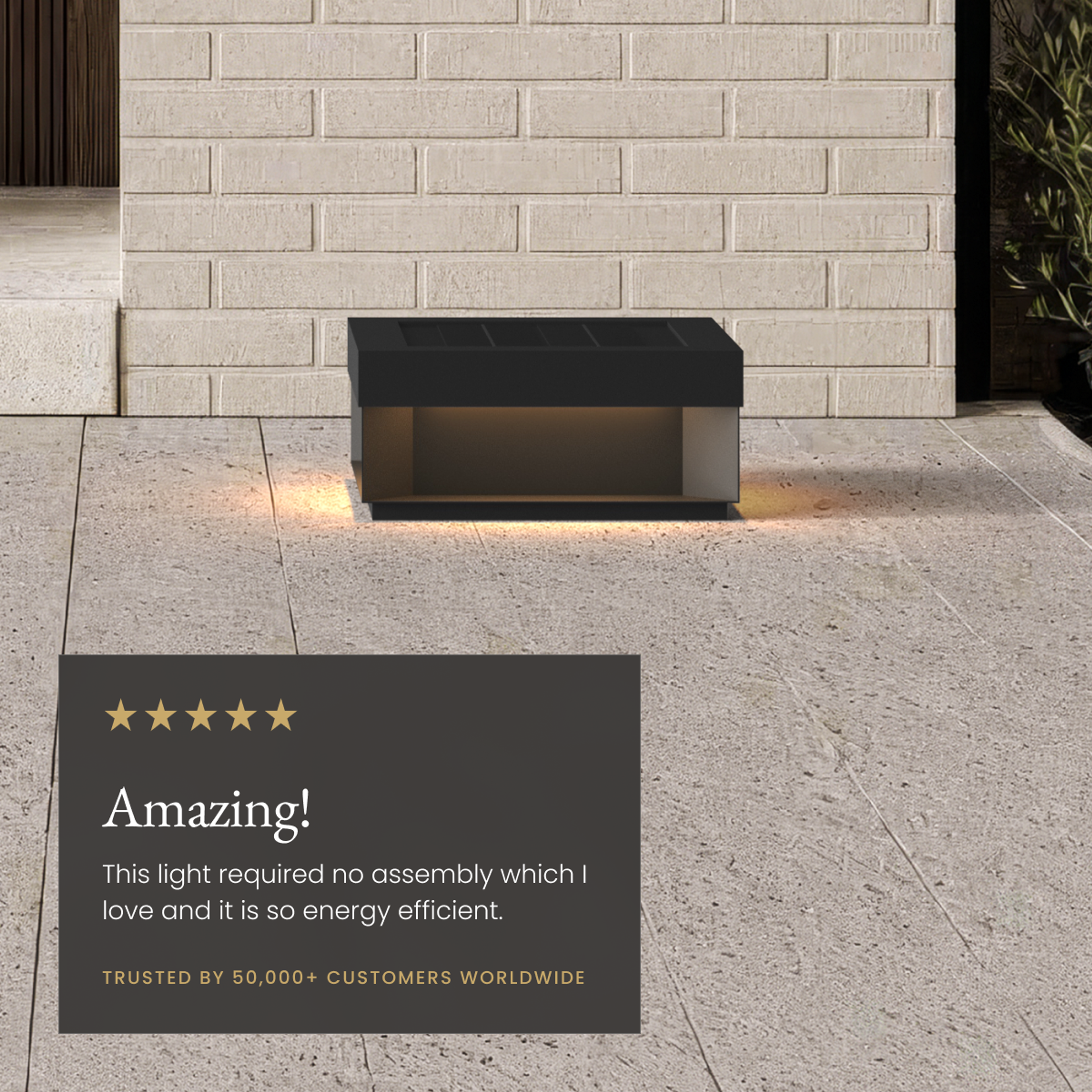 Chaz black solar outdoor lamp glowing downward on a paved patio, beside a five-star customer review card