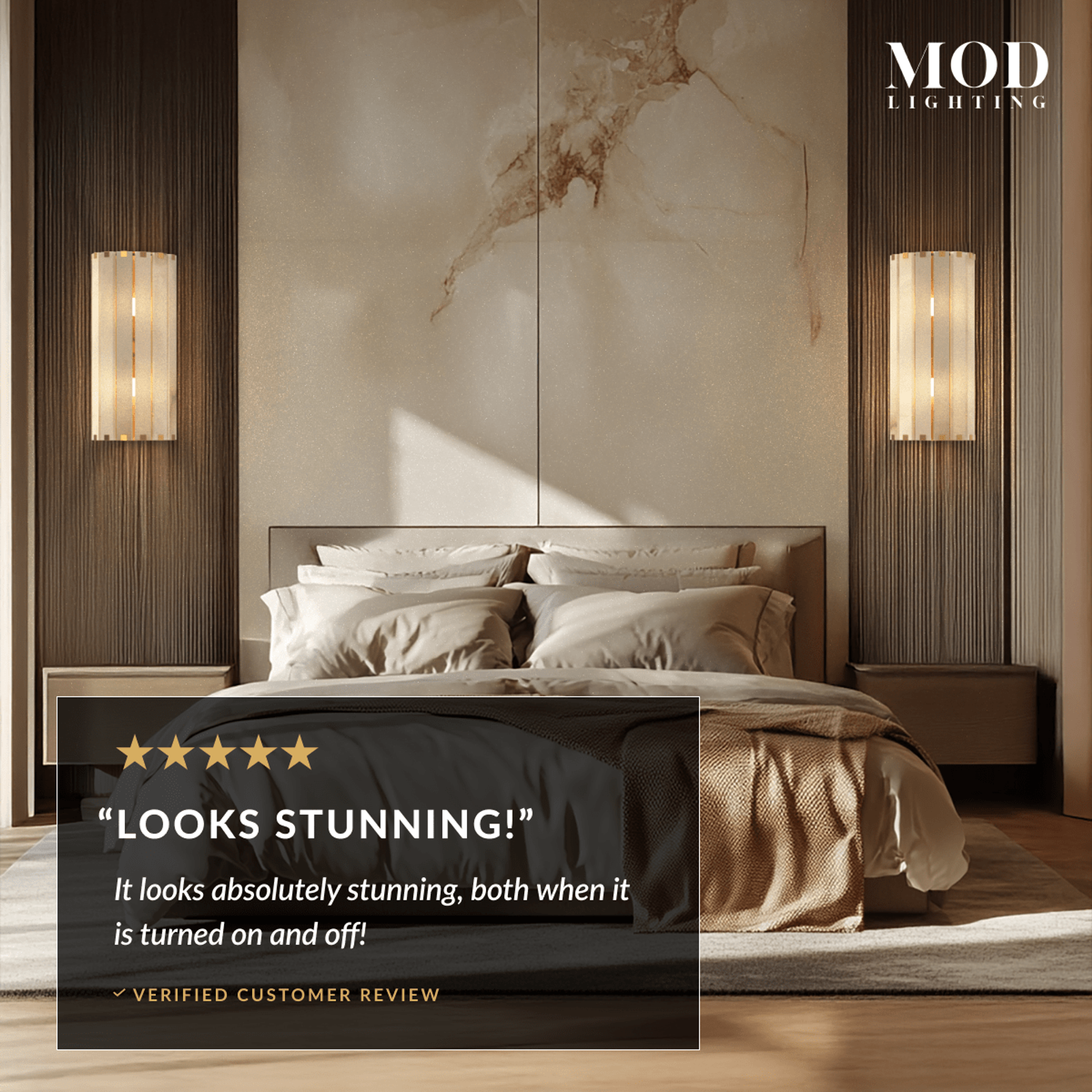 Two Nala alabaster wall sconces lit warm on either side of a bed with a marble headboard wall