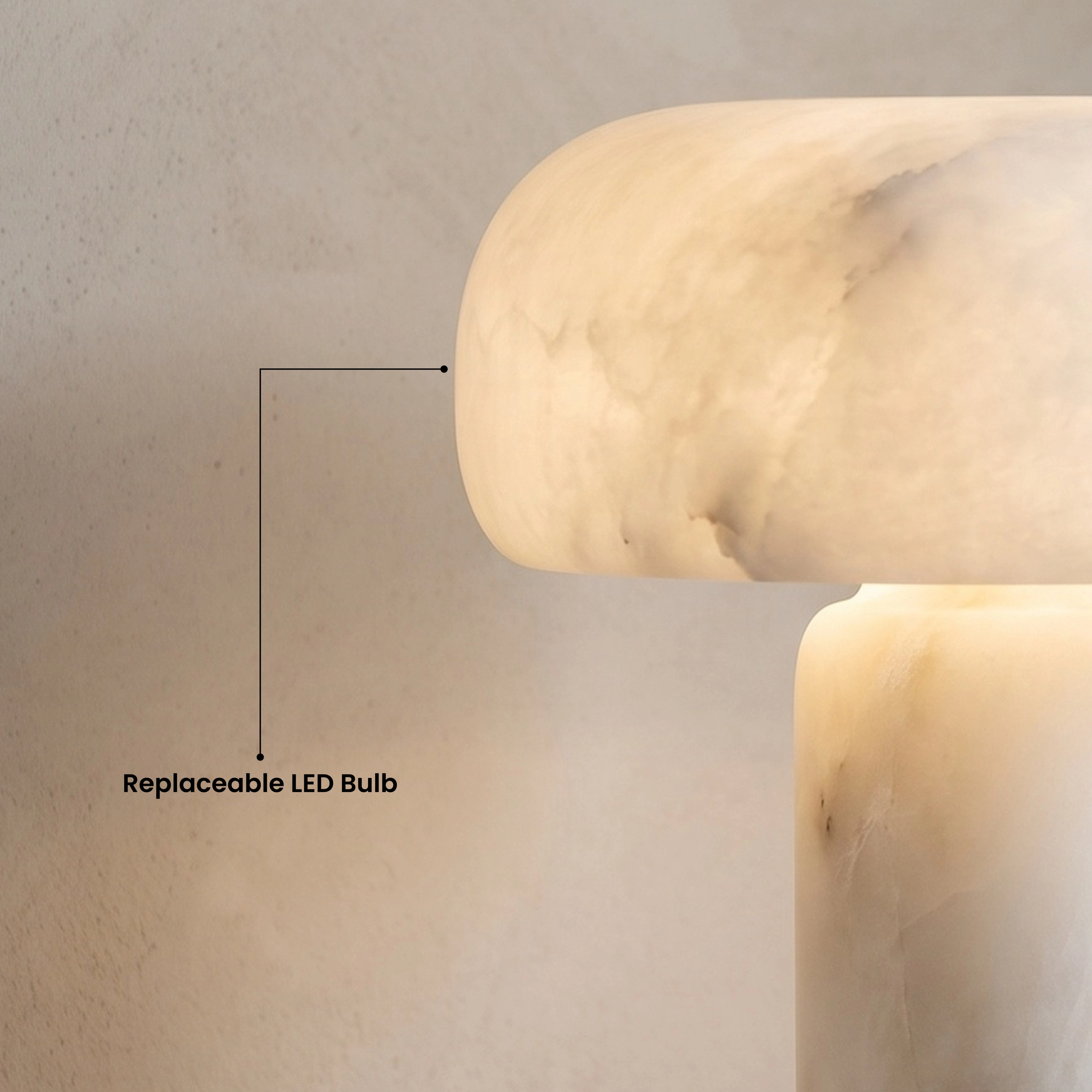 Ora Table Lamp glowing warm white on a round coffee table in a beige living room