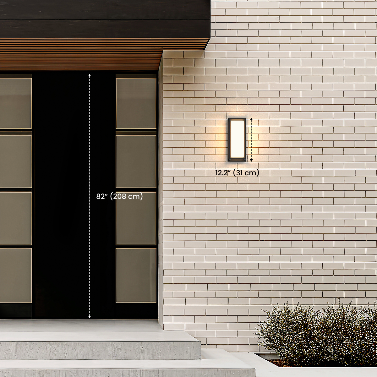 Hollis black square outdoor sconce by an entry door, dimension diagram noting 12.2 in / 31 cm height