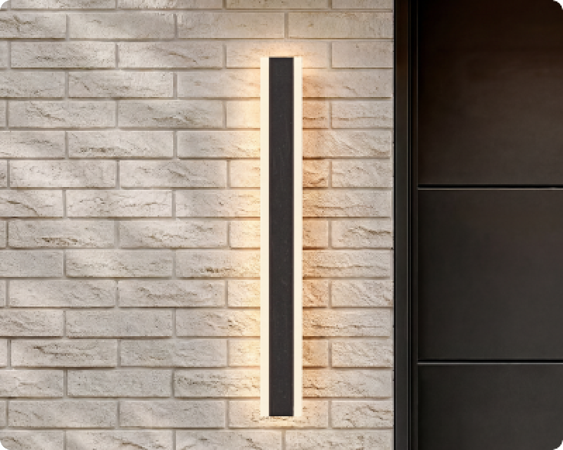 Haylen, a linear LED wall light, on a brick facade