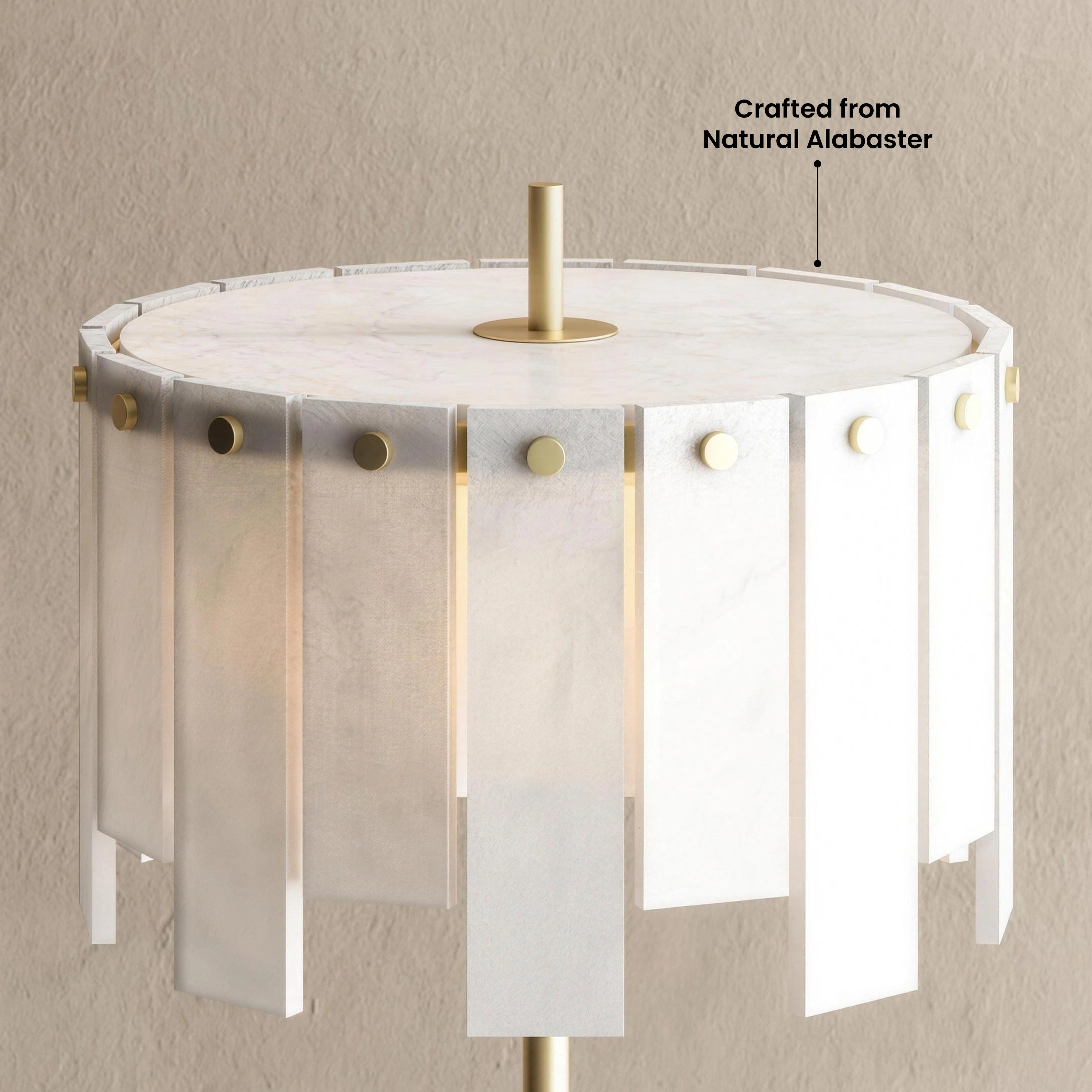 Velina Table Lamp gold base with panelled alabaster shade on a low table in a warm-toned seating area
