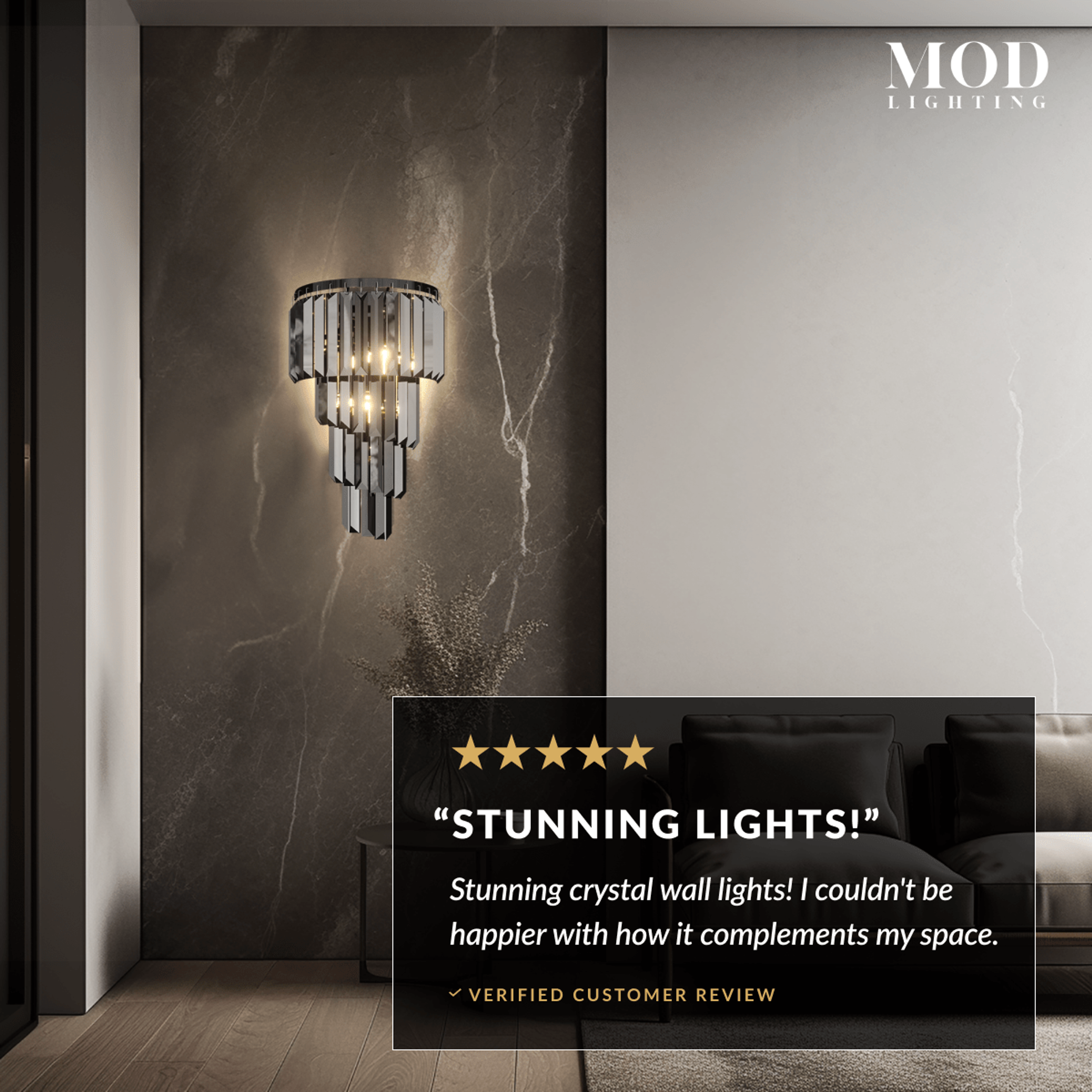 Umbra tiered crystal sconce glowing on a dark stone wall, with a five-star customer review