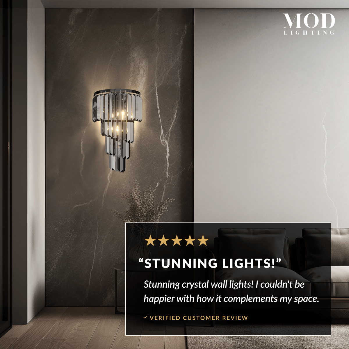 Umbra tiered crystal sconce glowing on a dark stone wall, with a five-star customer review