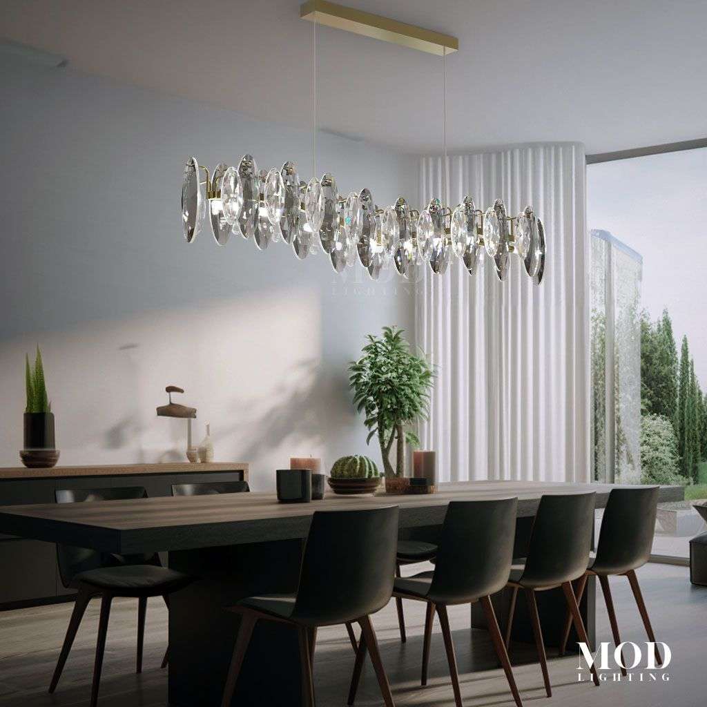 Celestial elongated crystal linear chandelier with gold canopy over a dining table