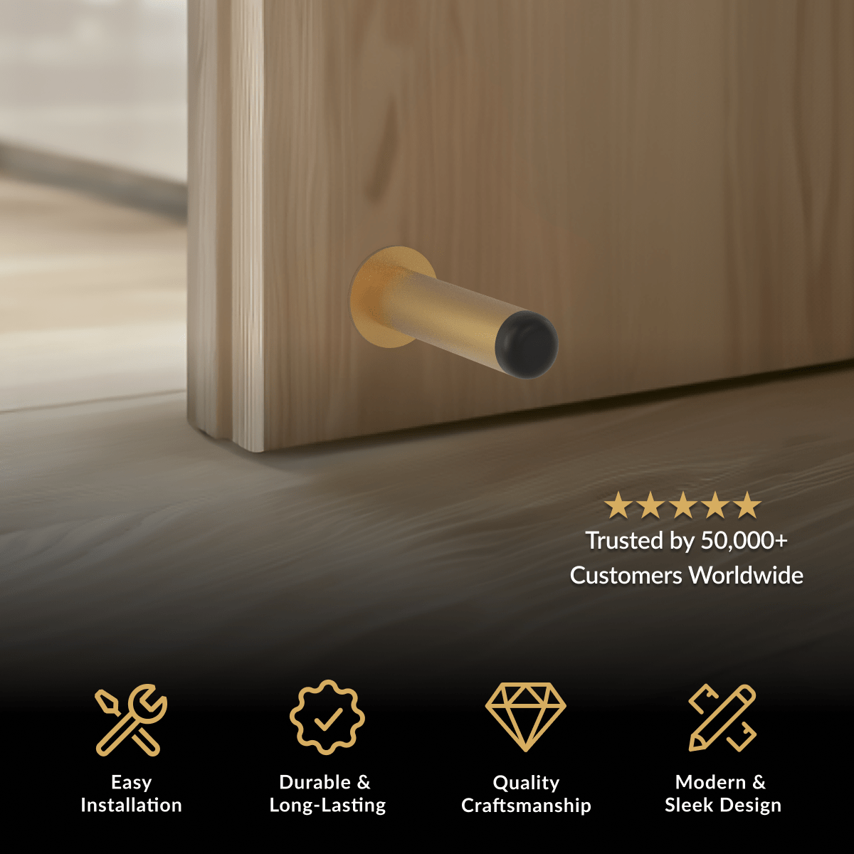 Aro Door Stop, brushed gold cylindrical wall-mounted stop with black rubber tip on a wood door