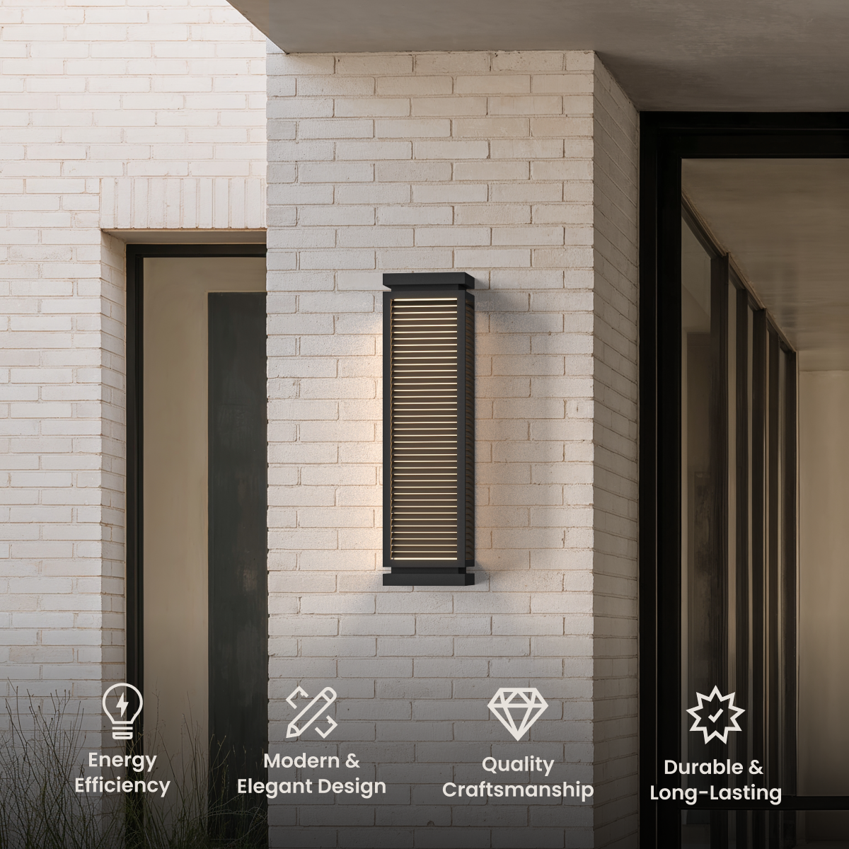 Fern, tall black louvered outdoor wall sconce mounted on a white brick exterior wall