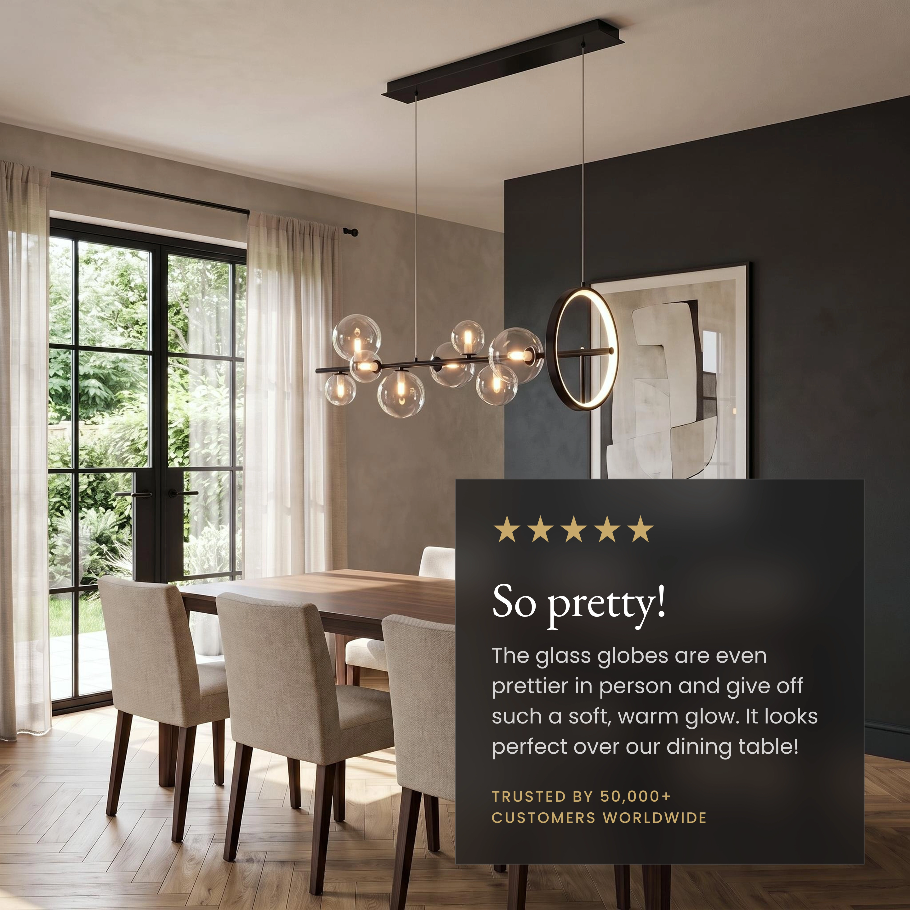 Bailey chandelier, black linear bar with clear glass orbs and a gold ring, over a dining table