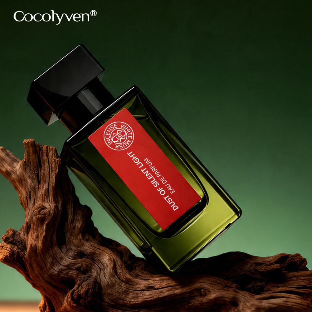 COCOLYVEN Silent Light Dust Perfume 50ml bottle on driftwood against a dark green background — ready stock perfume wholesale