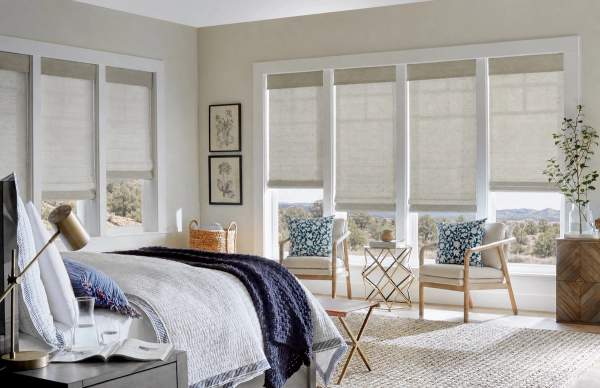 Natural woven shades with valances in bedroom