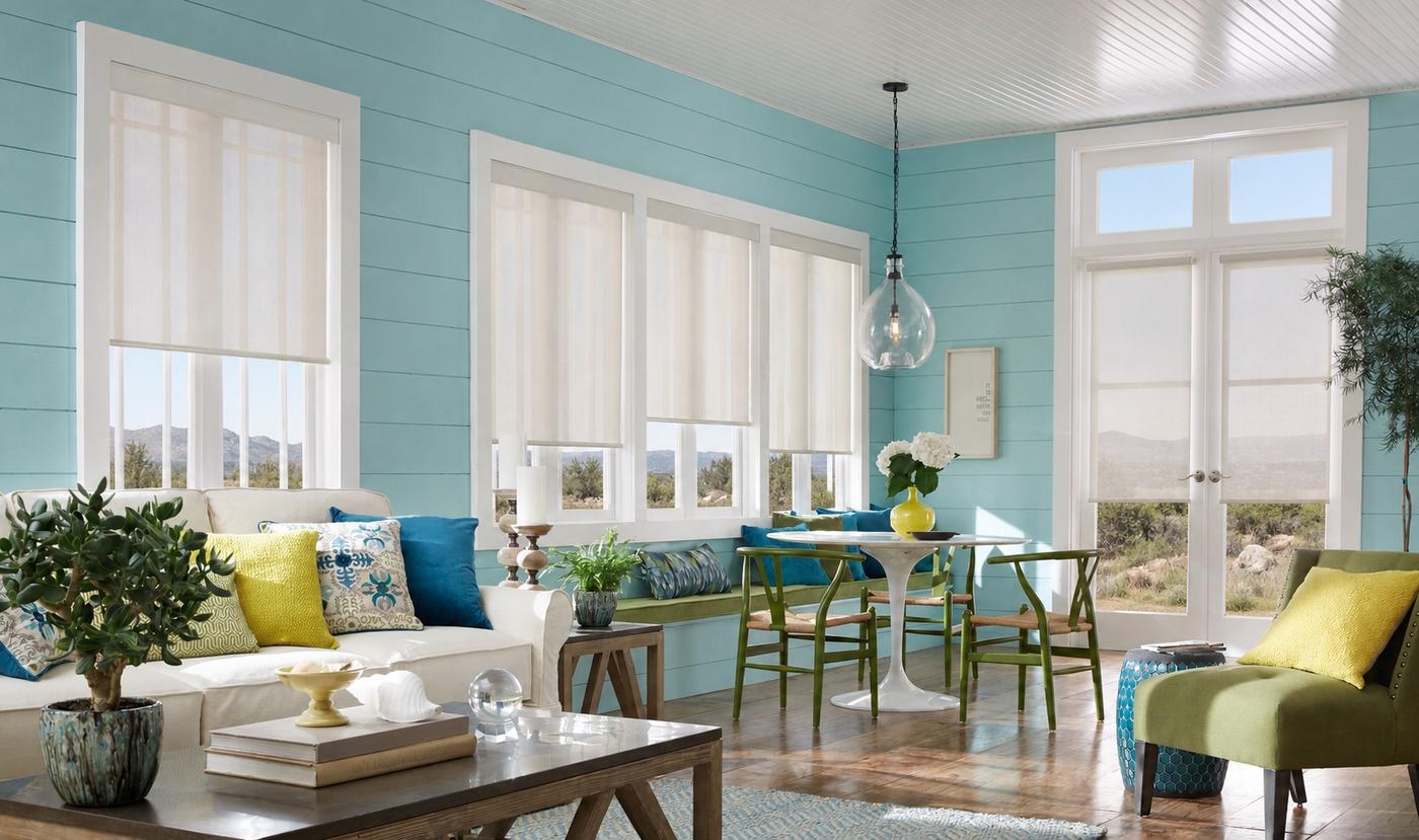 Cordless roller shades with motorized lift and remote control in sunroom