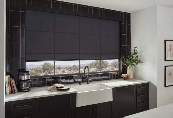 Black light filtering roller shade over kitchen sink and counter