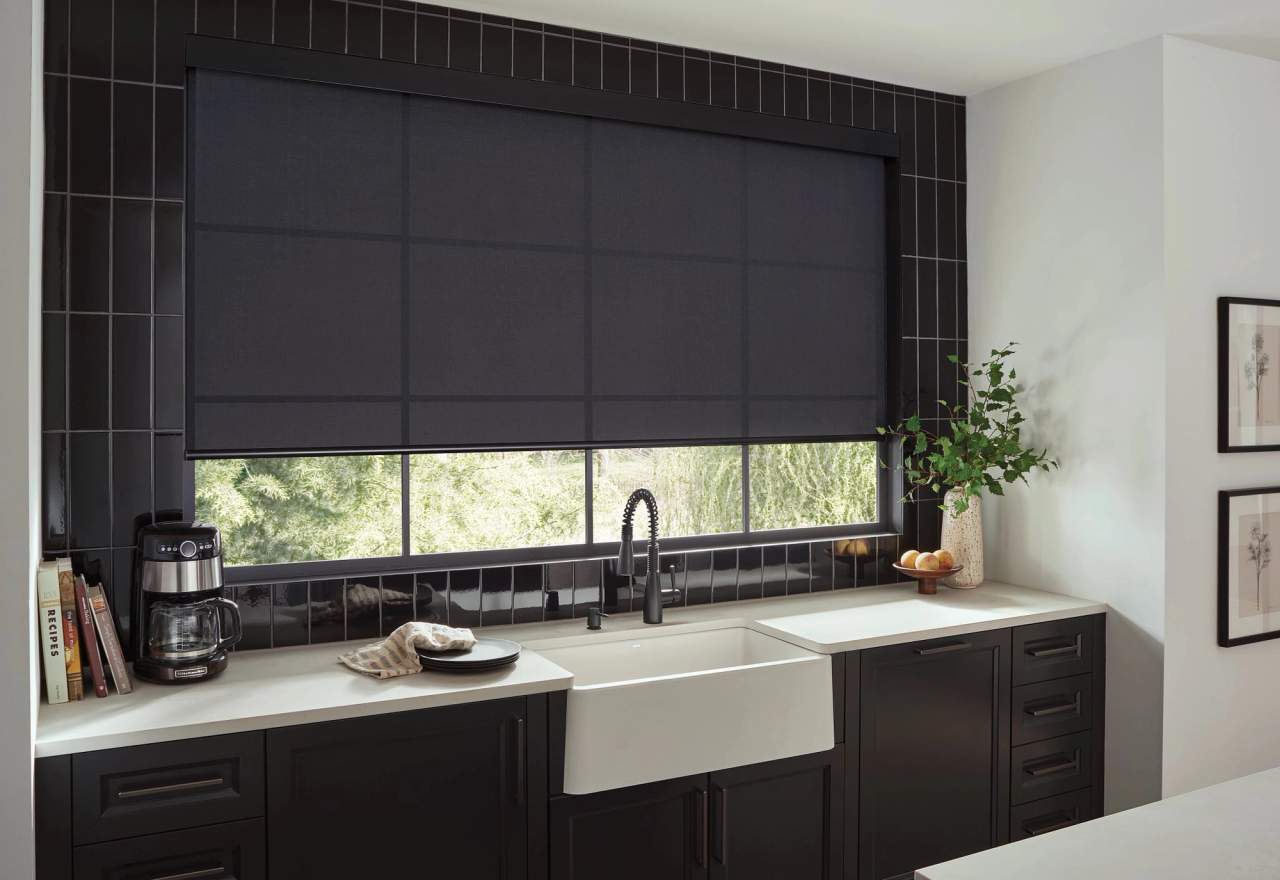 Roller shades in kitchen above sink