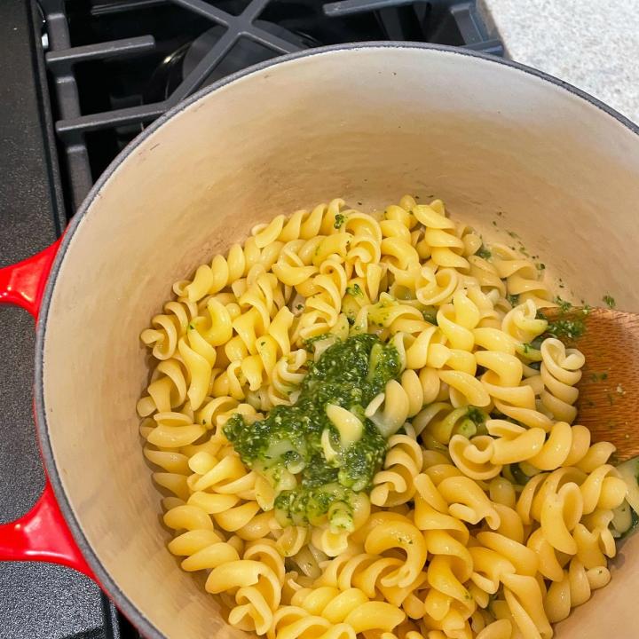 adding the pesto to the pasta