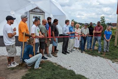 ribbon cutting at a community growing dome greenhouse