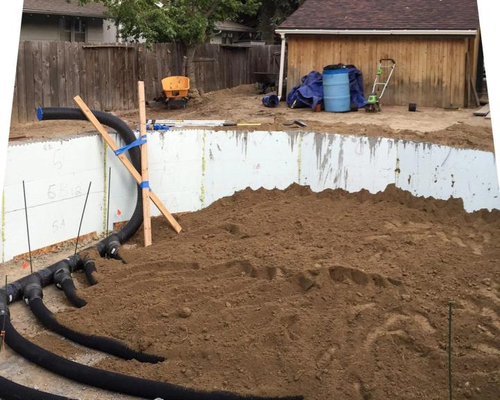 A partially buried climate battery for a greenhouse with an ICF foundation