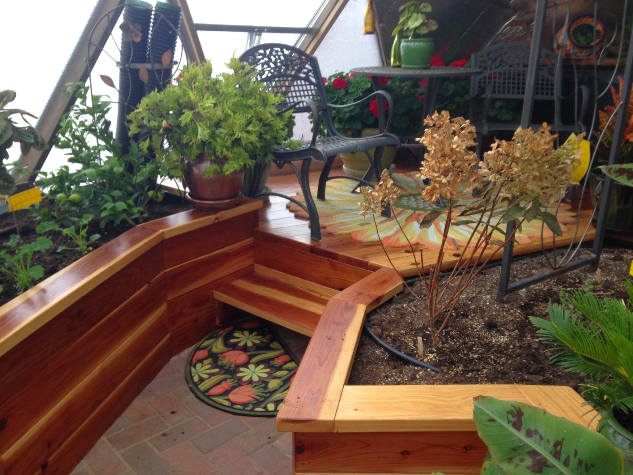 Custom deck with seating area inside a greenhouse