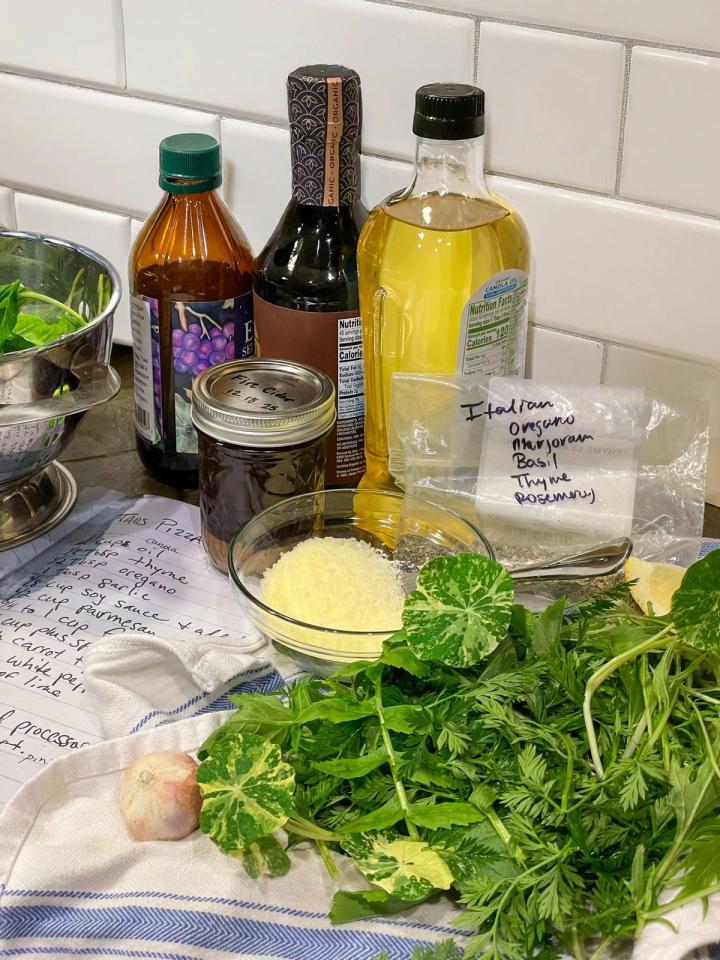 ingredients for the pesto on a countertop including greens, oil, vinegar, and soy sauce