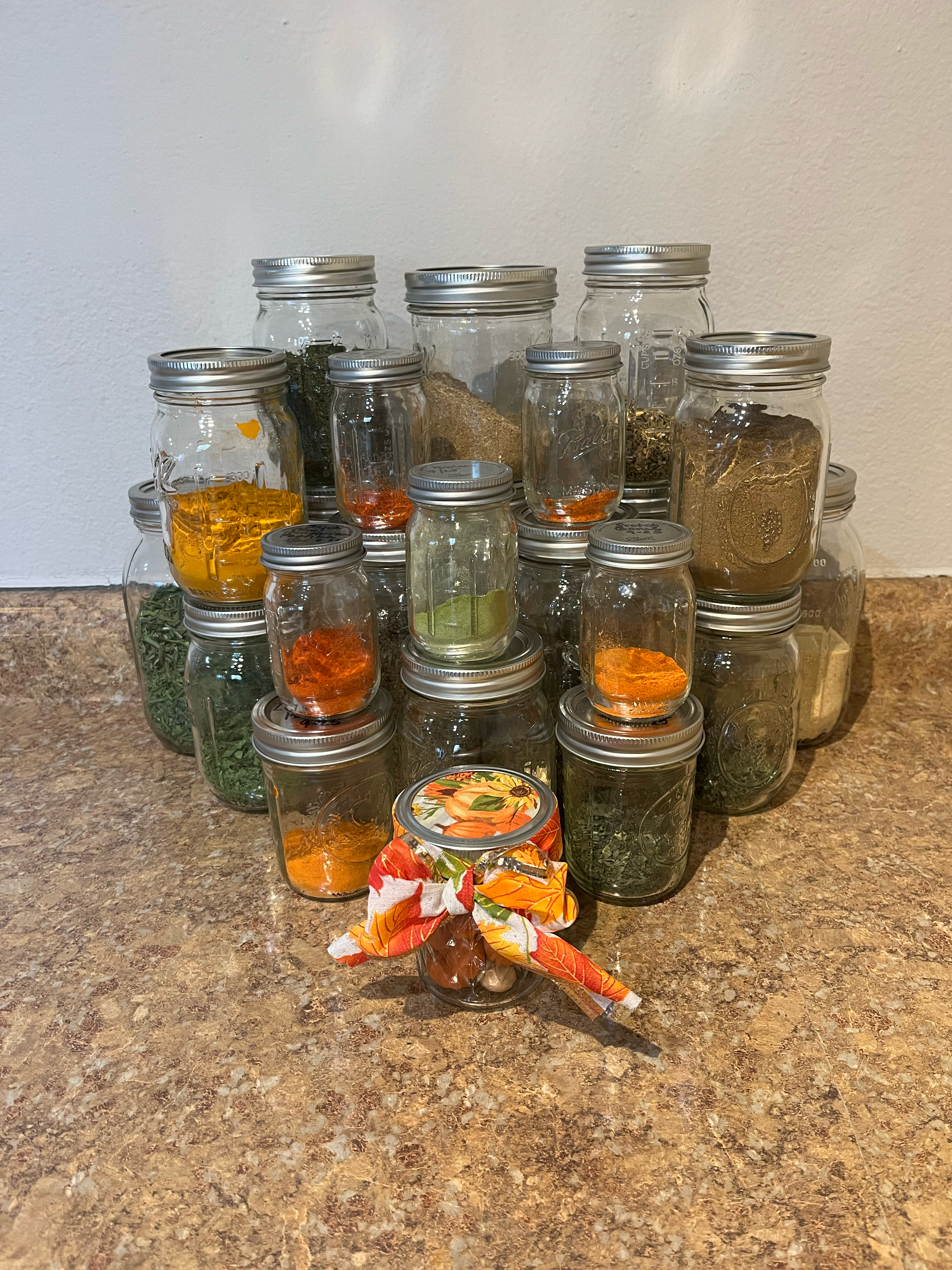stack of jars filled with dried herbs and spices