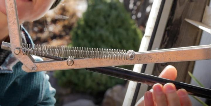 preparing a greenhouse for winter by disengaging vents