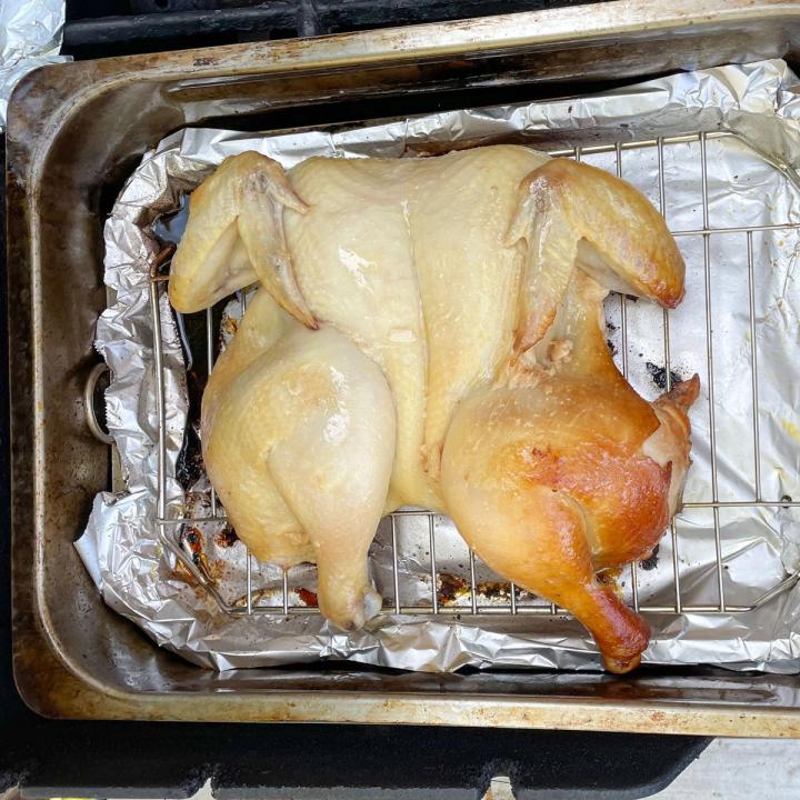 half cooked garlic chicken in a stovetop smoker pan