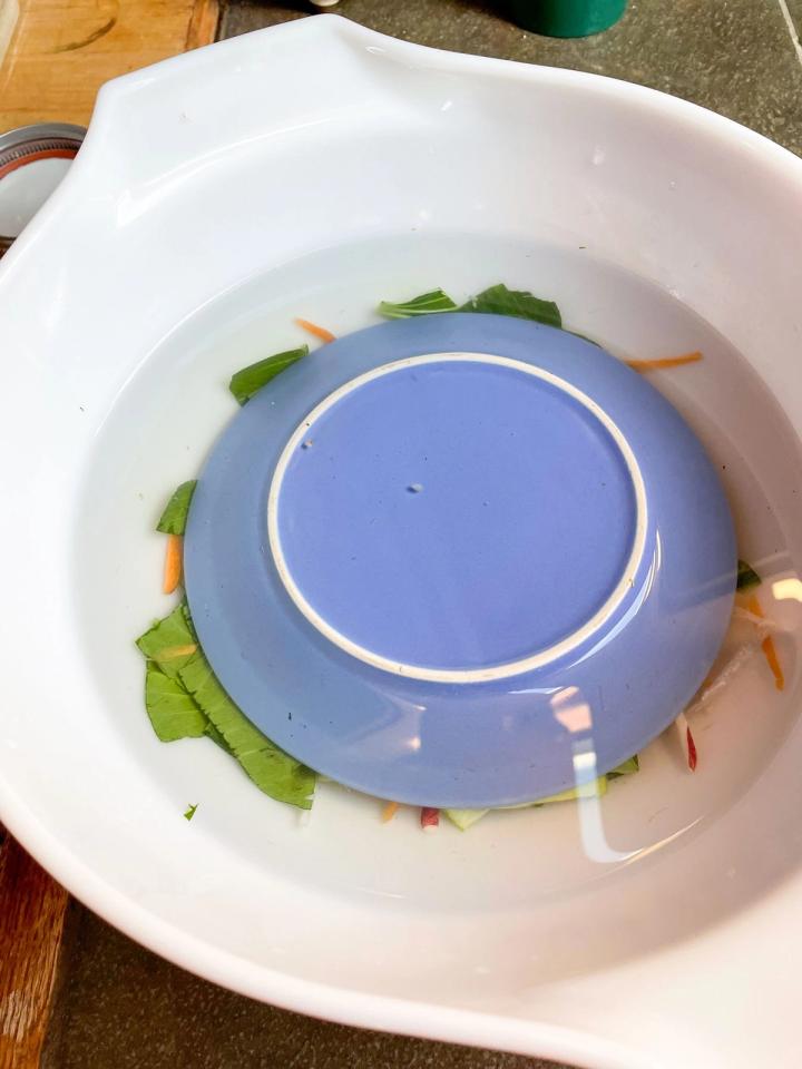 using an inverted, small plate to keep the vegetables submerged