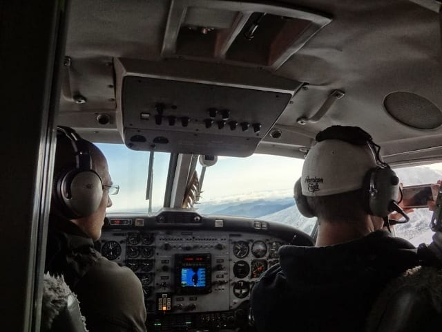greenhouse installers taking photos from plane