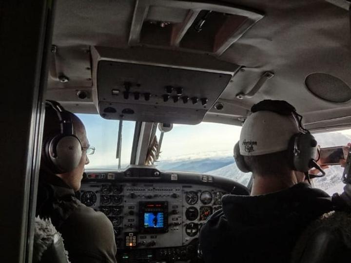 greenhouse installers taking photos from plane
