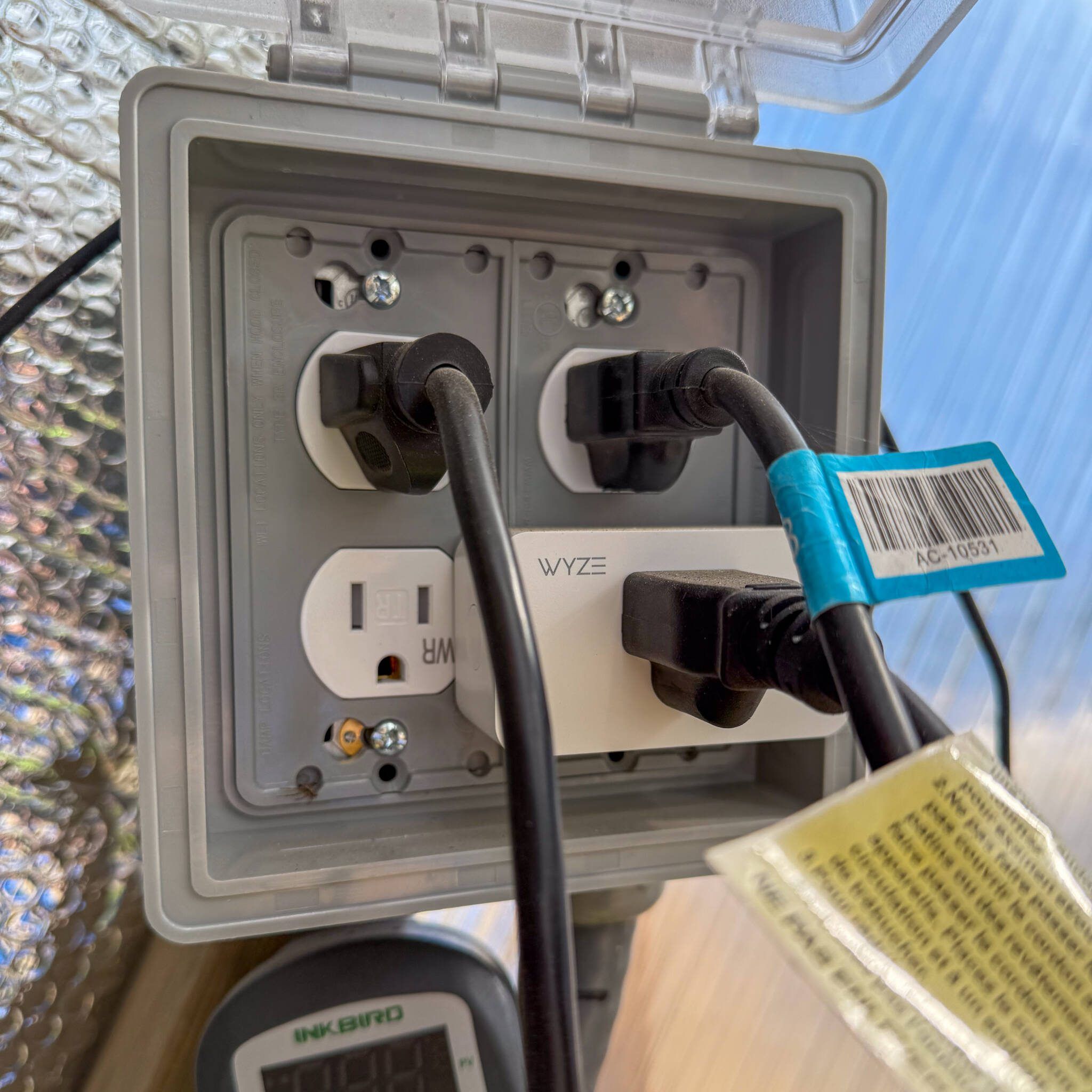 electrical outlet with 3 plugs and one wyze controller