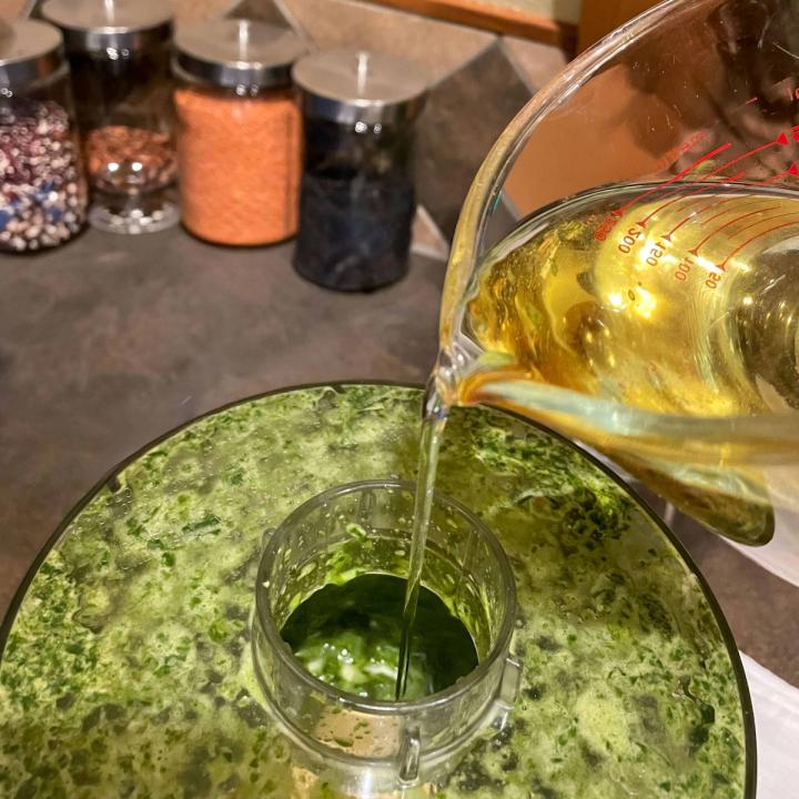 adding oil to the food processor