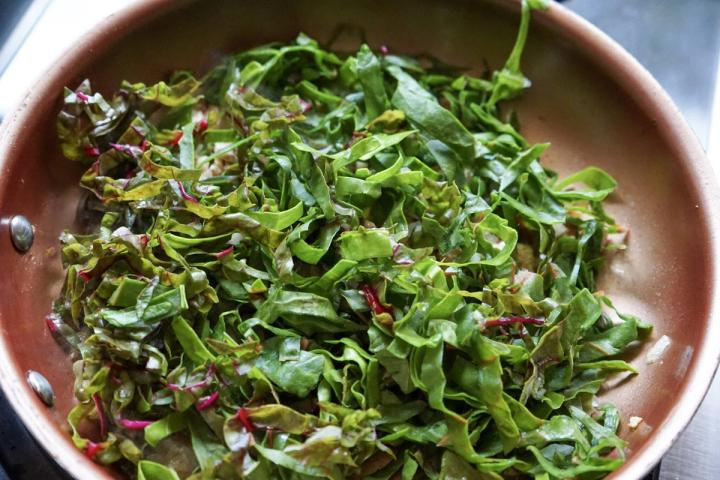 adding in the swiss chard and mushroom stems