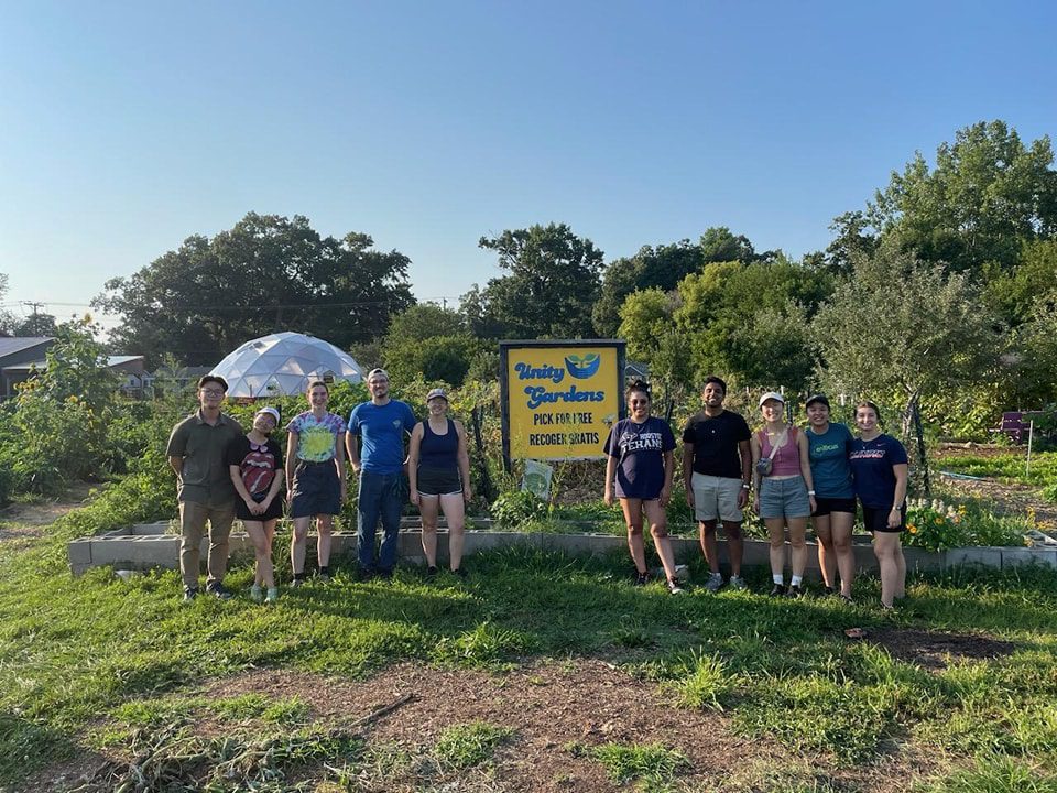 Volunteers posing for photo outside the Geodesic Greenhouse