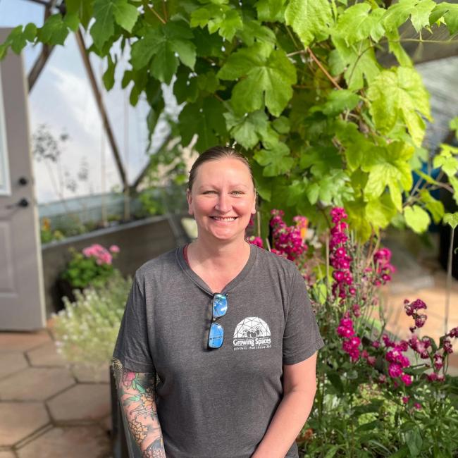 Headshot of Growing Spaces' Controller, Destiney Hilsabeck, inside a 33' Growing Dome.