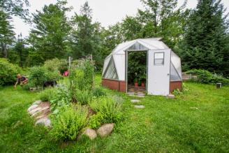 Landscaping outside sustainable greenhouse in Maine