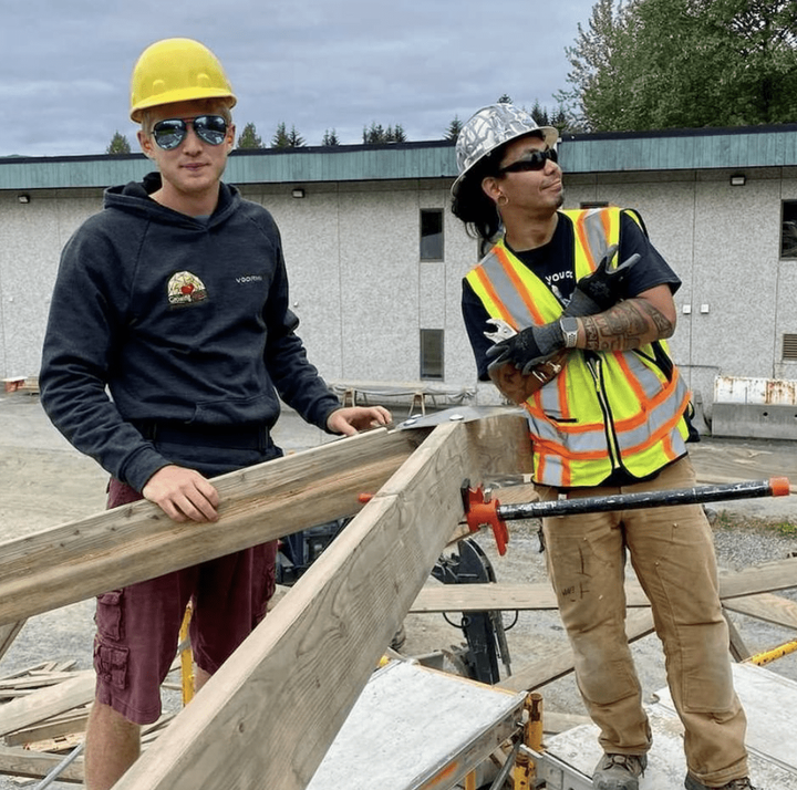 posing people building a greenhouse