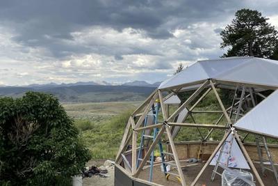 partially constructed growing dome greenhouse on a mountain mesa