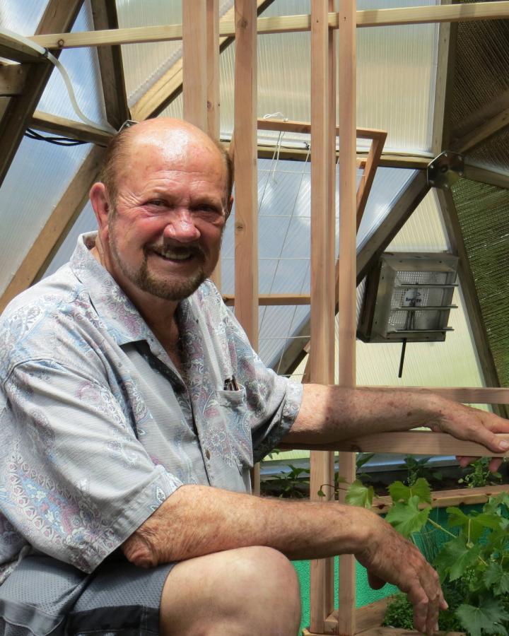 sunshine gardens senior community greenhouse director guy in the greenhouse