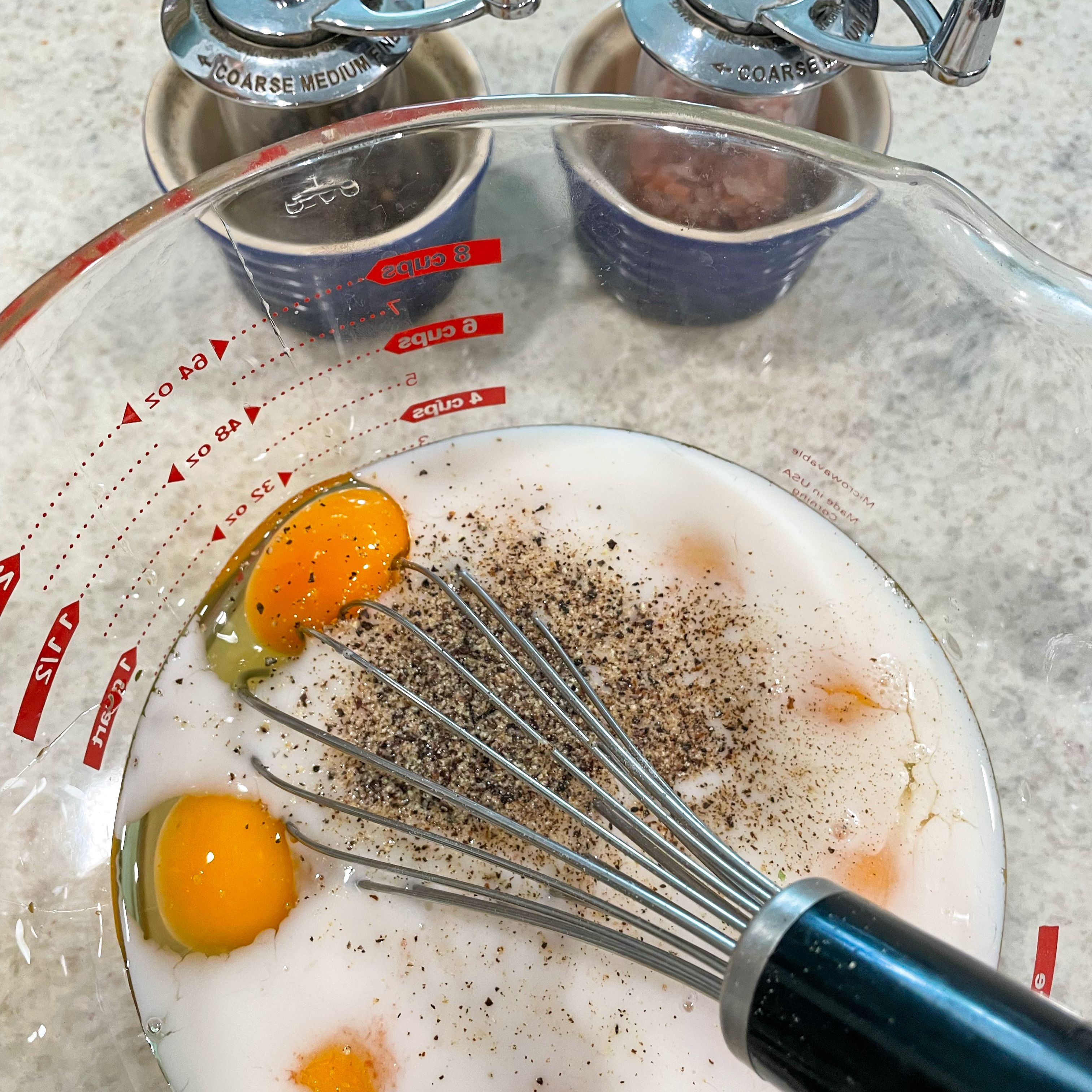 eggs milk salt and pepper in a large measuring cup ready to mix