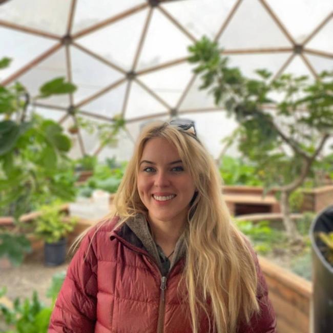 Portrait of Growing Spaces' People and Operations Manager, Laura Hamilton, inside a 42' Growing Dome.