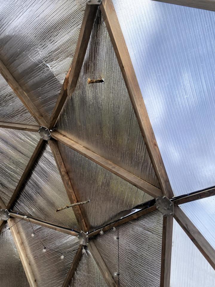 dome damage after ice storm shows a few branches sticking through the polycarbonate and reflectix