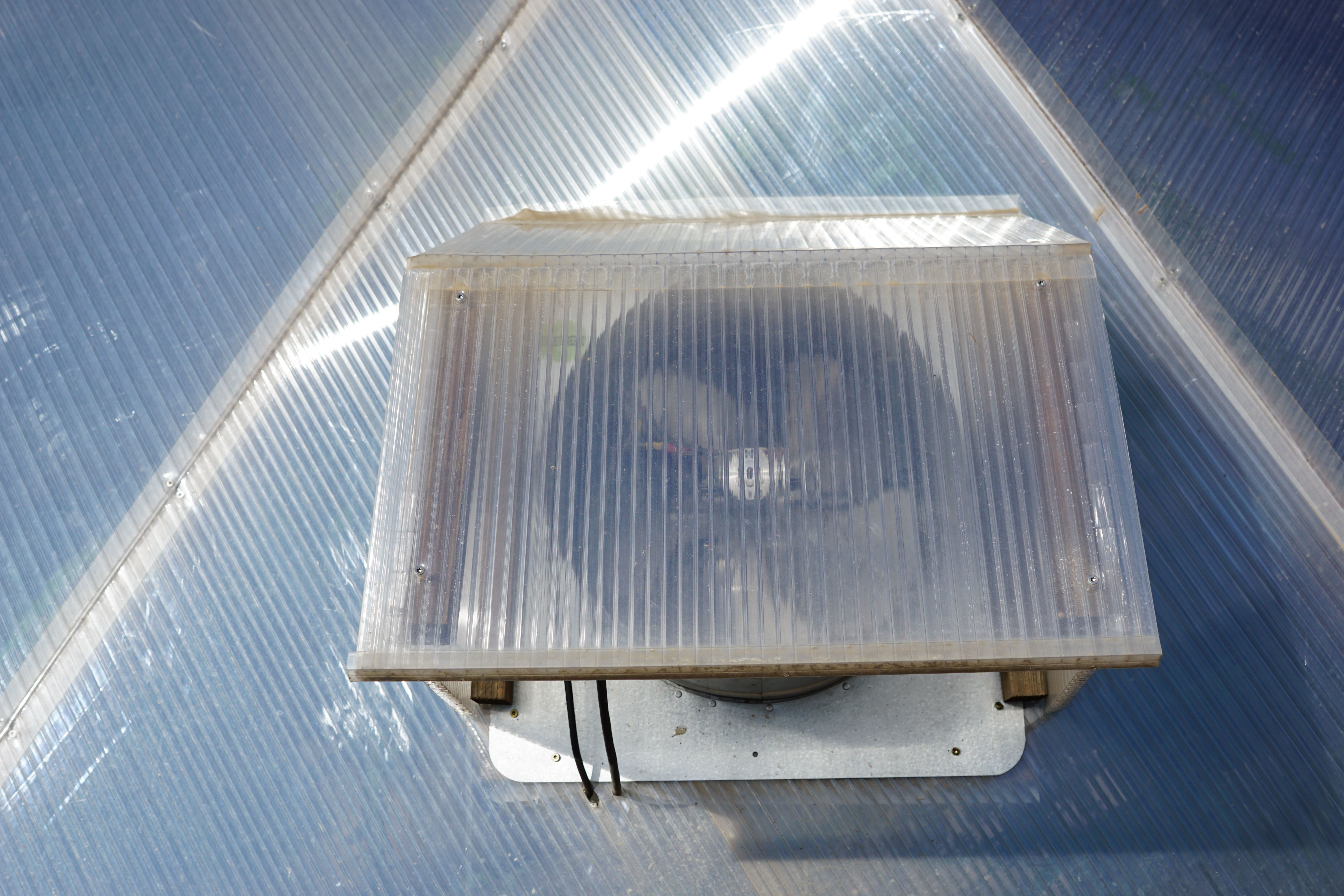 fan shroud on the outside of greenhouse