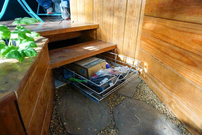 Drawer for storage hidden under stairs in a custom greenhouse interior