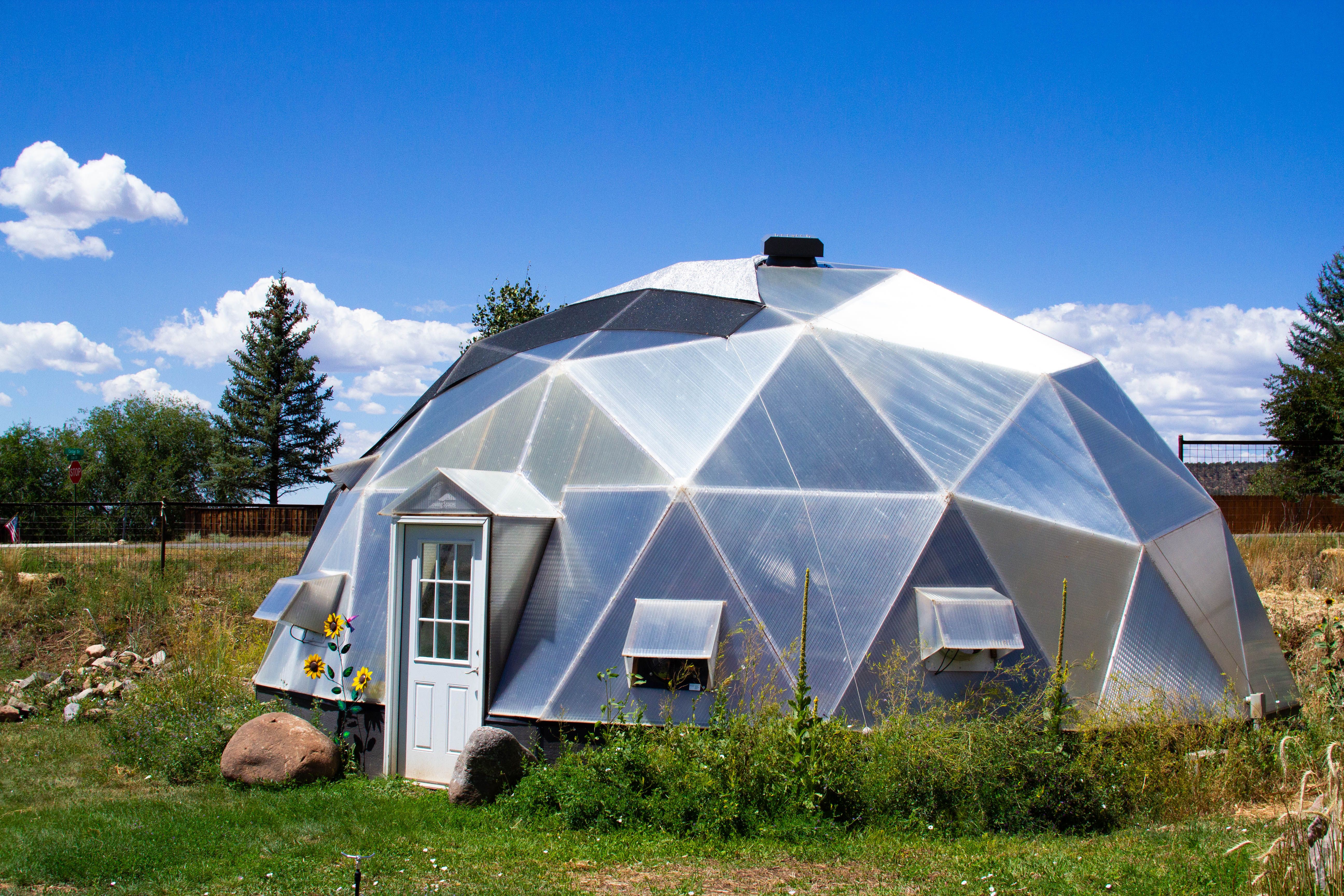 33 foot diameter growing dome backyard greenhouse with natural landscaping