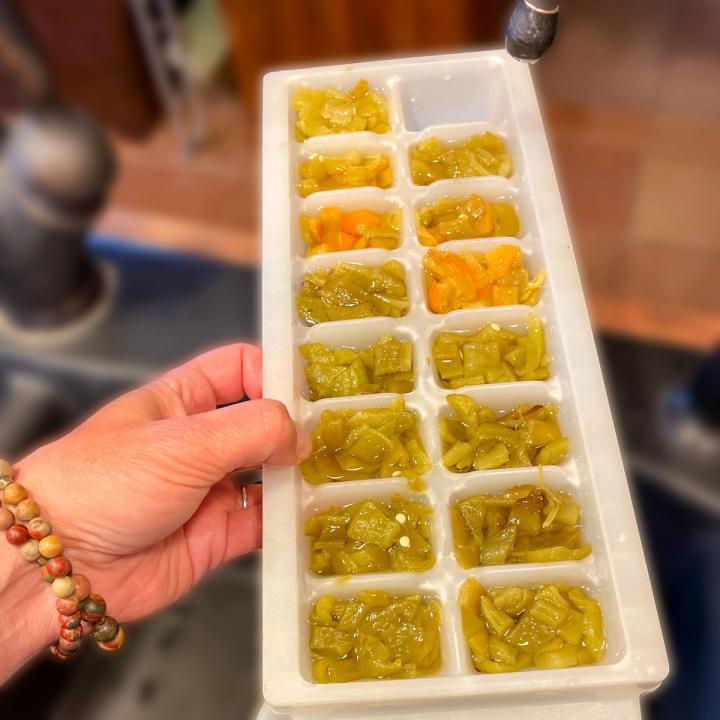 holding an ice cube tray filled with chopped green chiles an example of freezing food